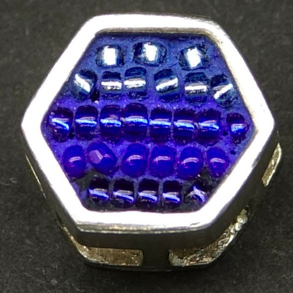 Hexagonal blue bead on a black background