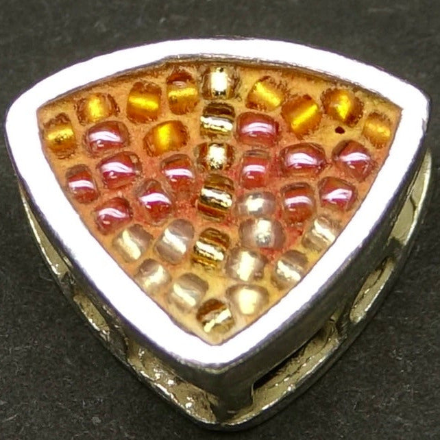 Triangular jewelry bead with multicolored mosaic on a dark background