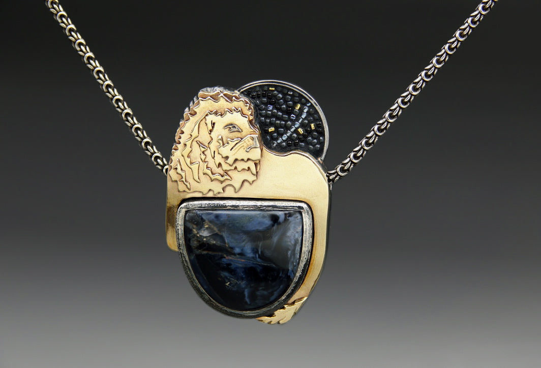 Load video: The making of a memorial pendant, in honor of beloved kitty, Rogue. Watch me melt old jewelry to repurpose into a new piece: forging ingots, annealing the metals, sawing, soldering, fitting, stone setting, and inlays.